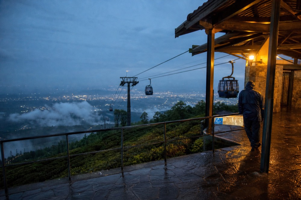 Cable car station platform at dusk with cabins arriving, no text, no logos, no people